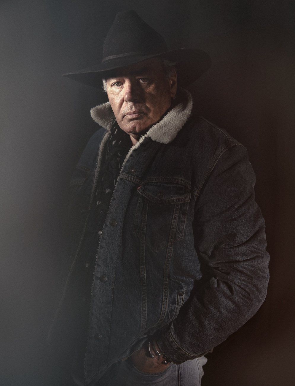 Portrait of a man in a hat and denim jacket by Dylan Madden
